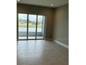 Bright living room with sliding glass doors leading to a patio overlooking the water at 24732 Buckingham Way, Port Charlotte, FL 33980