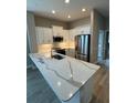 Modern kitchen with white cabinets and quartz countertops at 24788 Buckingham Way, Port Charlotte, FL 33980