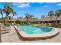 Beautiful community pool featuring lounge chairs and palm trees at 3375 Sandleheath # 34, Sarasota, FL 34235
