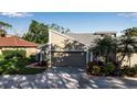 Tan two-story house with a two-car garage and palm trees at 3410 Avenida Madera # B, Bradenton, FL 34210