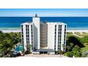 Aerial view of a beachfront high rise building with pool and parking at 4485 Gulf Of Mexico Dr # 803, Longboat Key, FL 34228