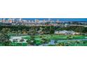 Aerial view of a golf course with city skyline in the background at 535 Sanctuary Dr # C807, Longboat Key, FL 34228