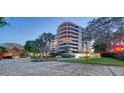 Luxury condo building with a brick driveway and landscaping at 535 Sanctuary Dr # C807, Longboat Key, FL 34228