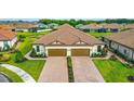 Two-unit home with two-car garages and a brick driveway at 5431 Taliaferro Ct, Palmetto, FL 34221