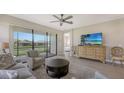 Open living room with access to patio and adjacent bedroom at 5431 Taliaferro Ct, Palmetto, FL 34221