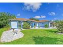 Charming light blue house with well-manicured landscaping at 6643 Lapidus Rd, North Port, FL 34291