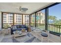 Bright sunroom with water views and comfy seating at 8779 Midnight Pass Rd # 206H, Sarasota, FL 34242