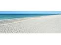 Wide, sandy beach with calm ocean waters at 8779 Midnight Pass Rd # 206H, Sarasota, FL 34242