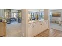 Open concept kitchen with white cabinets and breakfast bar at 8779 Midnight Pass Rd # 206H, Sarasota, FL 34242