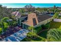 One-story green house with brown roof, landscaping, and a driveway at 10550 Old Grove Cir, Bradenton, FL 34212