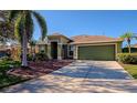 Green house with palm tree and driveway at 10550 Old Grove Cir, Bradenton, FL 34212