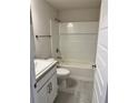 Bright bathroom featuring a shower-tub combo, white tile surround, and stylish vanity with gray countertops at 1157 Duquesne Rd., Venice, FL 34293