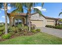 Beautiful house exterior with three-car garage, stone accents, and lush landscaping at 2520 Avolet Ct, Bradenton, FL 34211