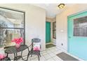 Front entry with teal door and small patio set at 3843 3Rd W Ave, Palmetto, FL 34221