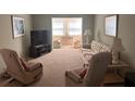 Bright living room with comfy seating and a view to another room at 611 Gulf N Dr # D24, Bradenton Beach, FL 34217