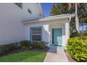 Inviting teal front door entrance with landscaping at 6591 Fairway Gardens Dr # 2-102, Bradenton, FL 34203