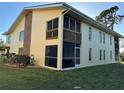 Condo building exterior with screened patio and lush green lawn at 6699 San Casa Dr # U2, Englewood, FL 34224