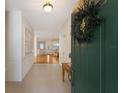 Bright entryway with green door and view of living area at 7144 Spikerush Ct, Lakewood Ranch, FL 34202