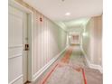 Building hallway with striped wallpaper and carpet at 750 N Tamiami Trl # 302, Sarasota, FL 34236