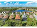 Aerial view of community, showcasing houses near a lake at 11435 Fort Lauderdale Pl, Venice, FL 34293