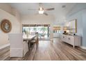 Bright dining room with hardwood floors, a large table, and access to a screened patio at 23095 Langdon Ave, Port Charlotte, FL 33954