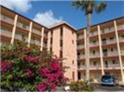 Two-story condo building with lush landscaping at 3935 Lake Bayshore Dr # F-316, Bradenton, FL 34205