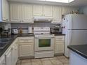 White cabinets, dark countertops, and full-size appliances at 3935 Lake Bayshore Dr # F-316, Bradenton, FL 34205