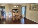 Dining room features hardwood floors and a round table at 4924 Live Oak Cir # 115, Bradenton, FL 34207