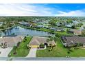 Aerial view of a waterfront home in a community at 5663 Country Lakes Dr, Sarasota, FL 34243