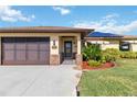 Front view of a house with a brown door, brick accents, and a screened garage at 7231 Brookhaven Ter, Englewood, FL 34224