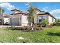 One-story house with a two-car garage and manicured lawn at 10128 Morning Mist Ln, Sarasota, FL 34241