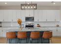 Modern kitchen with island and white cabinets at 17015 Harvest Moon Way, Bradenton, FL 34211