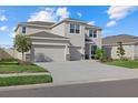 Two-story house with three-car garage and front yard at 17015 Harvest Moon Way, Bradenton, FL 34211