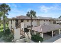 Two-story condo building with Spanish tile roof and carport at 208 Lewis Cir # 4A, Punta Gorda, FL 33950