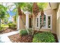 House entrance with columns, landscaping, and walkway at 246 Petrel Trl, Bradenton, FL 34212