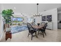 Bright dining room features a farmhouse table and chairs, and access to the living room and kitchen at 5831 Mezzana Run, Palmetto, FL 34221