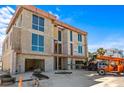 Under-construction home with large windows, unfinished exterior, construction machinery, and a blue sky at 6489 Gulfside Rd, Longboat Key, FL 34228
