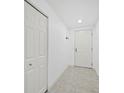 Simple entryway with white doors and light flooring at 800 N Tamiami Trl # 307, Sarasota, FL 34236