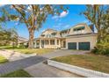 Large two-story home with a wrap-around porch and two-car garage at 810 S Edison Ave, Tampa, FL 33606