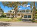 Large two-story home with a wrap-around porch and two-car garage at 810 S Edison Ave, Tampa, FL 33606