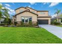 Two-story house with stone accents and a landscaped lawn at 13148 Bliss Loop, Bradenton, FL 34211
