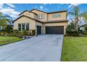 Two-story house with dark-colored garage doors and a landscaped lawn at 13148 Bliss Loop, Bradenton, FL 34211