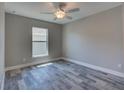 Sunny bedroom with wood-look floors and a ceiling fan for added comfort at 160 Apollo Dr, Rotonda West, FL 33947