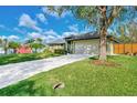 House exterior showcasing a large yard and driveway at 17040 Kellog Ave, Port Charlotte, FL 33954