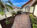 Relaxing patio with brick pavers, landscaping, and a charming fountain at 198 Carriage House Ln # 198, Nokomis, FL 34275