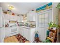 White kitchen features stainless steel appliances and ample cabinet space at 2057 Garden Pkwy, Bradenton, FL 34205