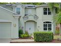 Front view of a two-story house featuring a light green exterior and double front doors at 228 36Th Ne St, Bradenton, FL 34208