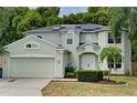 Two-story house with a green facade, solar panels, and a well-maintained lawn at 228 36Th Ne St, Bradenton, FL 34208