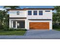 Modern home featuring a two-car garage, contemporary windows and minimalist landscaping at 2425 Floyd St, Sarasota, FL 34239