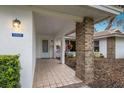 Covered entryway with brick columns and tile flooring at 5502 Garden Lakes Oak, Bradenton, FL 34203